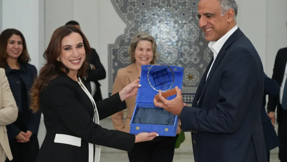 Ambassador Talwar accepts a gift from Douaa Ben Imran